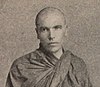 Head and shoulders of a 50-year-old European man in Burmese monk's robes