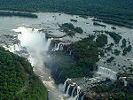 A large waterfall falling into a horseshoe shaped gorge.