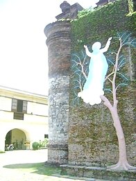 The relief of Our Lady of Assumption on a tree on the first front buttress