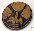Attic red-figure lid depicting three vulvae and a winged penis