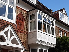 Details like sunflower panels and corbelled bay windows found only on Shaw's early houses