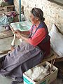 A Tibetan woman spinning wool in Pokhara, Nepal