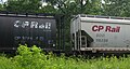 Reporting marks on two CP Rail covered hoppers passing Wisconsin Dells, Wisconsin.