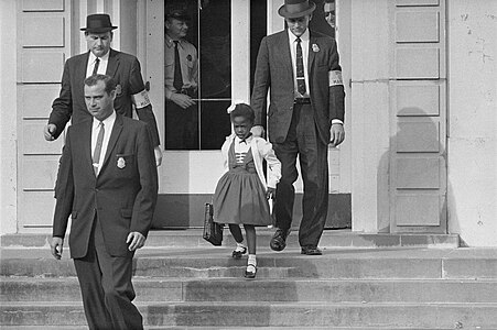 Ruby Bridges being escorted by U.S. Marshalls at New Orleans school desegregation crisis, by the United States Department of Justice (restored by Adam Cuerden)