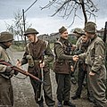 British and American troops shake hands on the Anzio Road during World War II.