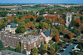 an aerial shot of a college campus, with several large buildings among trees