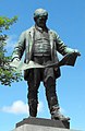 Statue of David Davies, holding the plans for Barry Docks, at Llandinam