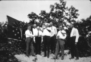 The state flag next to Governor Ed Jackson as he presents the deed of the first purchase of the Indiana Dunes State Park, 1925.