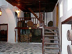 Entryway, with stone floor and wooden stairs