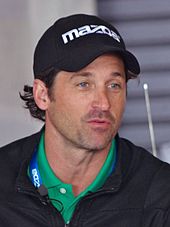 Patrick Dempsey wearing a cap looking away from the camera