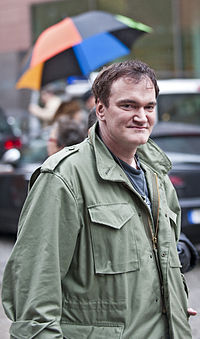 Quentin Tarantino at the Berlin Film Festival in 2009. An out-of-focus and colorful umbrella can be seen in the background.