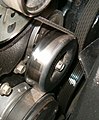 Serpentine belt on belt tensioner in an automobile engine