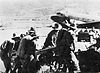 At Wau aerodrome 25-pounders are unloaded. These guns were assembled and went straight into action.