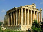 Fairly well preserved classical building surrounded by columns.