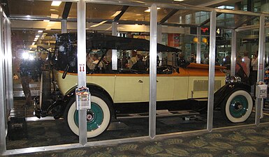 Antique auto protected by display case