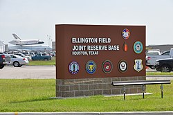 The entrance to Ellington Field Joint Reserve Base in 2012, with the Space Shuttle Endeavour arriving in the background