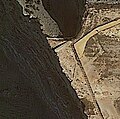 Aerial photograph showing the outline of the former defensive wall of the fort by the cliff's edge..