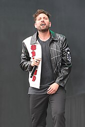 A picture of a man performing on stage.