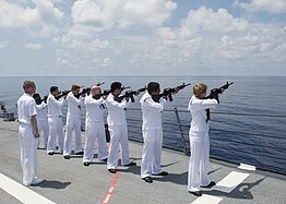 Sailors aboard the USS William P. Lawrence perform a Three-volley salute during a Memorial Day ceremony in honor of Keating.