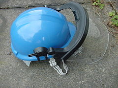 Baseball cap style safety helmet with visor and chin strap
