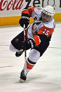 Jeff Tambellini shooting the puck on the ice.