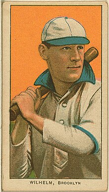 A baseball card image of a man wearing a baseball uniform and cap and holding a baseball bat over his shoulder