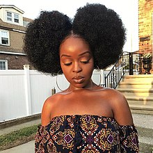 A woman with afro puffs