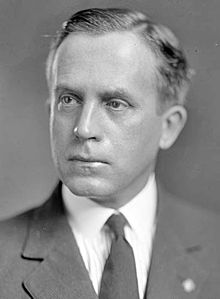 Upper-body portrait of a man in a suit.