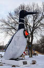 20-foot tall concrete sculpture of a black and white bird