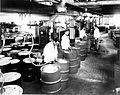 Filling drums with lube oil, circa 1950