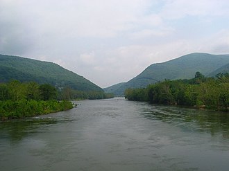 river surrounded by hills covered with green trees