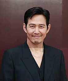 Lee smiling dressed in black shirt