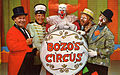 1968 postcard, main cast of Bozo's Circus (WGN-TV); left to right, Ringmaster Ned (Ned Locke), Mr. Bob (bandleader Bob Trendler), Bozo the Clown (Bob Bell), Oliver O. Oliver (Ray Rayner), Sandy the Clown (Don Sandburg)
