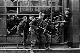 Members of the SS-Sonderregiment Dirlewanger fighting in Warsaw, pictured in window of a townhouse at Focha Street, August 1944