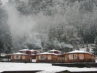 Snow-covered cottages near Curarrehue, Chile
