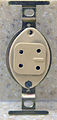 The front of a US four-pronged telephone jack (1964)