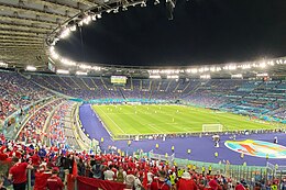 The stadium at night, seen from the stands