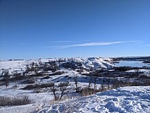 Snowy landscape with blue skies.