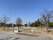 Trees, a statue, and footpaths in the park (2023)