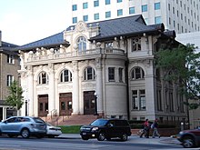 A romanesque building on a street in a city