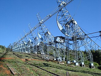 The 530-metre (1,740 ft) long and 30-metre (98 ft) tall cylindrical parabolic antenna at Ooty Radio Telescope Complex near Ooty, Tamil Nadu, India (Early 1970s)