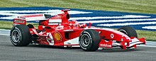 Photo of Michael Schumacher driving a red Ferrari on a race track