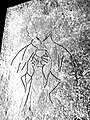 Enhanced outline of figure incised on slab, showing chalice held to the chest and clerical vestments.