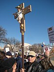 Protester at the 2009 March for Life in Washington, DC holds a crucifix with the Infant Jesus