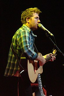 Lawson onstage with a guitar