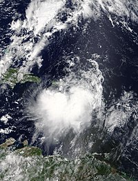 Tropical Storm Karen on September 24, 2019. Land can be seen above and below the storm. The storm is slightly asymmetrical.