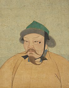 A portrait of a Mongol man wearing an orange robe and a pointed green cap; his mustache and beard are long and thin.