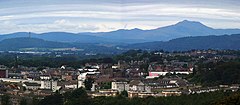 A town landscape with hills in the background.