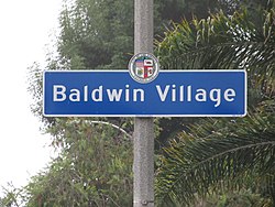 Street sign marking the border of the Baldwin Village neighborhood, located at the intersection of Obama Boulevard and Martin Luther King Jr. Boulevard