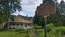 a picture of the marker with the house behind it